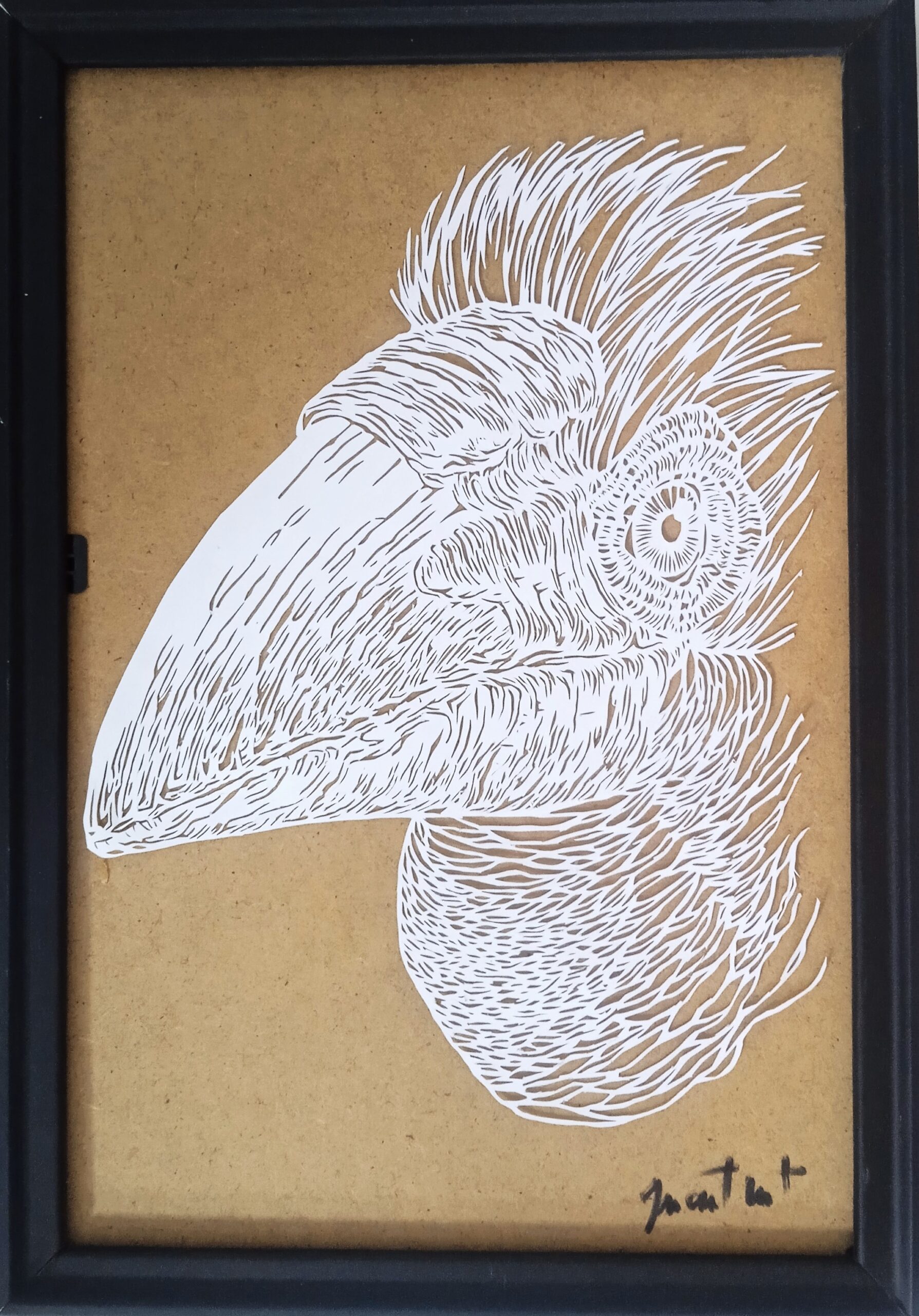 un tableau d'un toucan en papier découpé